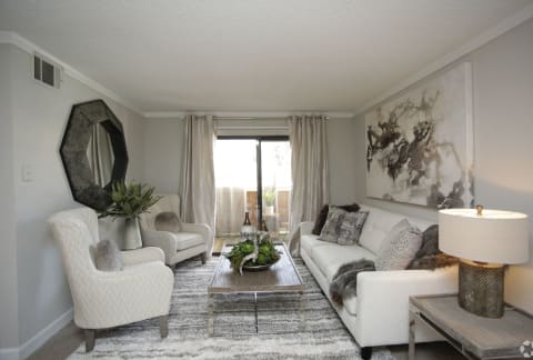 a living room with white furniture and a rug at Lodge of Overland Park Apartments, Overland Park , 66212