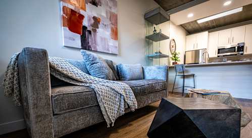 a living room with couches and chairs and a video game on a table