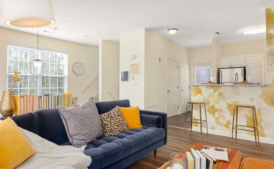 Living room area with view and couch at The Residences at Stevens Pond