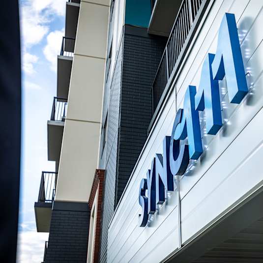 a sign on the side of a building with the name of a hospital