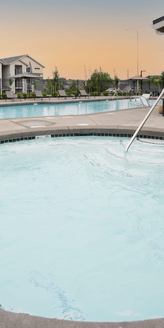 a large swimming pool with a building in the background at Sonder Fields in Happy Valley, OR
