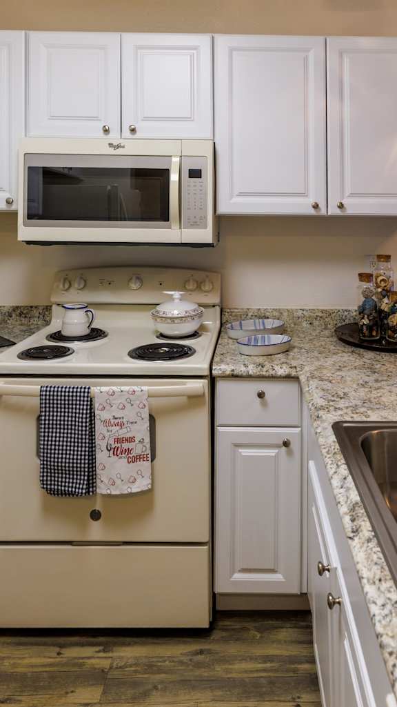a kitchen with stainless steel appliances and a granite counter top