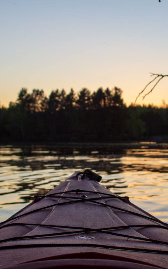 the view from the cockpit of a kayak on a lake at sunset at Preserve at Sycamore Creek, Osage Beach