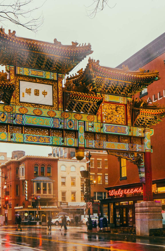 the archway of the chinatown gate on a rainy city street