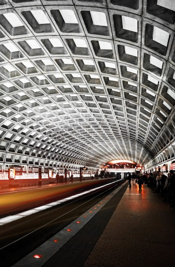 a train passing through a tunnel at a metro station
