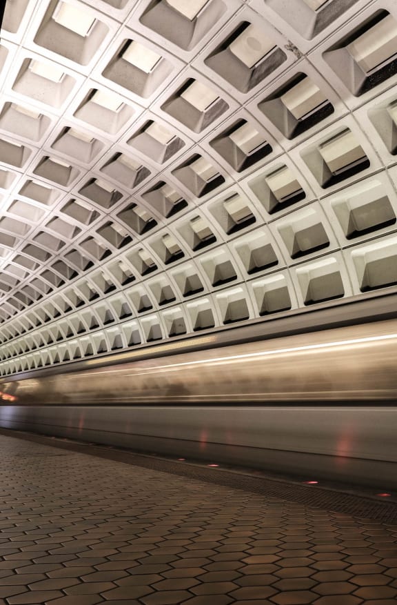 a subway train speeding through a subway station