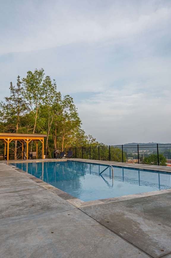 A pool with a yellow structure in the background.