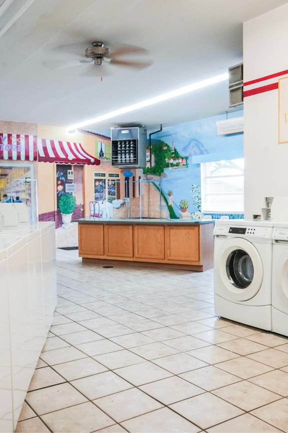 A laundromat with a sign that says "No Children Allowed".