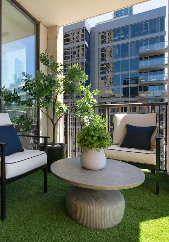 A patio with a chair and a table with a potted plant on it at Chateau on Wells, Chicago, Illinois