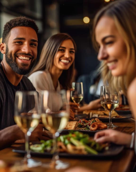 group of people eating and drinking at a restaurant