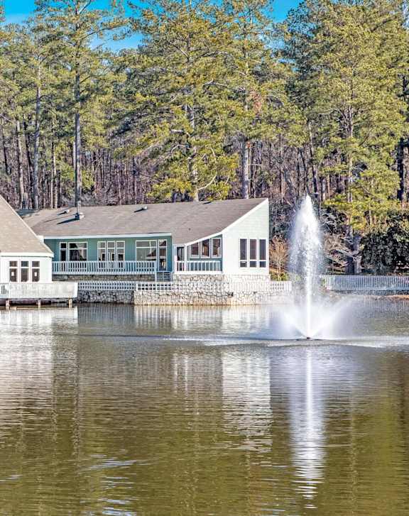 A building with a fountain in front of it.