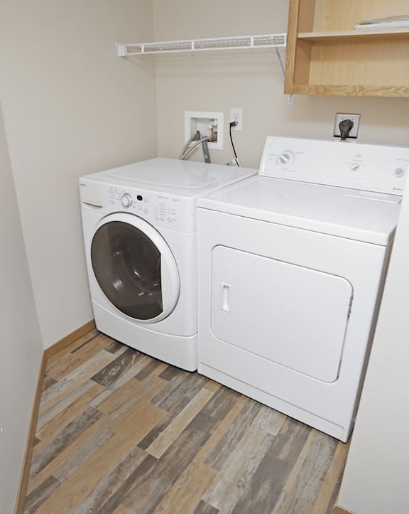 A white washing machine and dryer in a small laundry room.