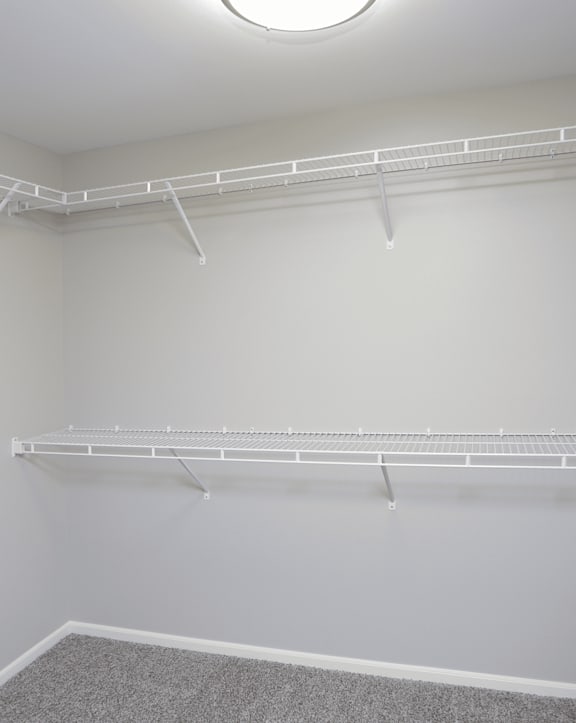 Empty white shelves in a room.