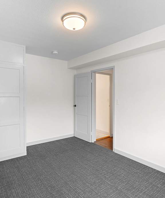 a renovated living room with white walls and white closets