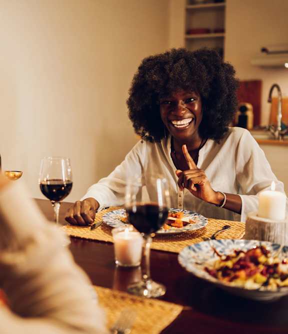 A man and a woman are preparing food together in a kitchen.