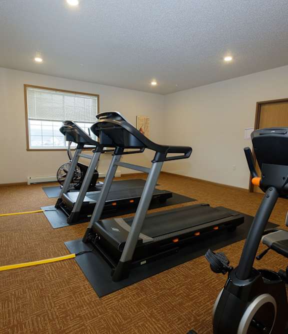 a bedroom with a large bed and a window. Fargo, ND North Sky Apartments