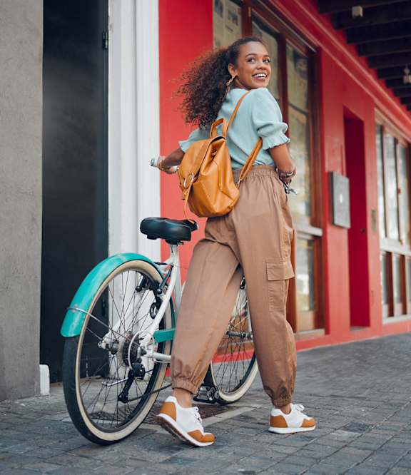 Woman walking with bicycle at Elements of Linden Hills, Minneapolis, 55410