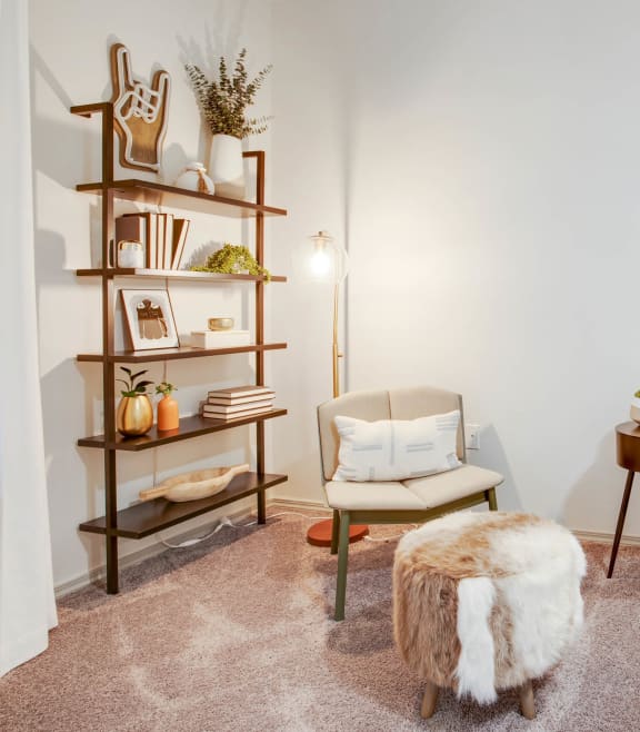 bedroom with book shelves a chair and a round table at The Olivine in North Austin, Texas