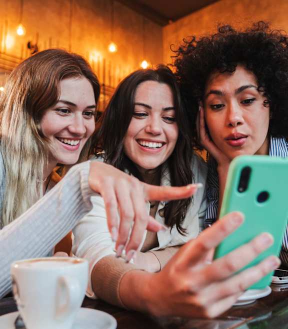 Friends Looking at the Phone at Manchester at Mansell in Roswell, GA, 30076