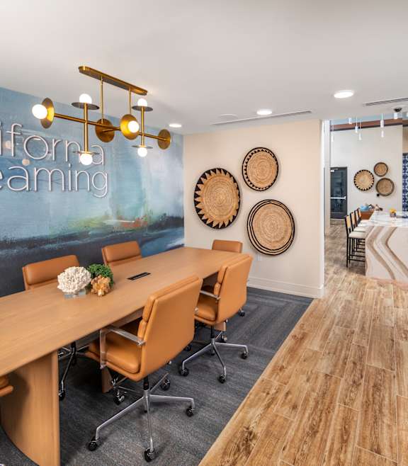 A conference room with a long table and chairs.