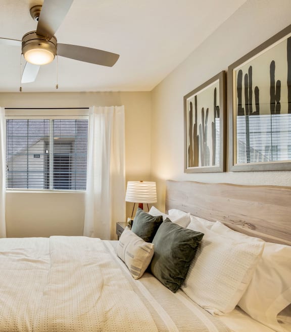 a bedroom with a large bed and a ceiling fan