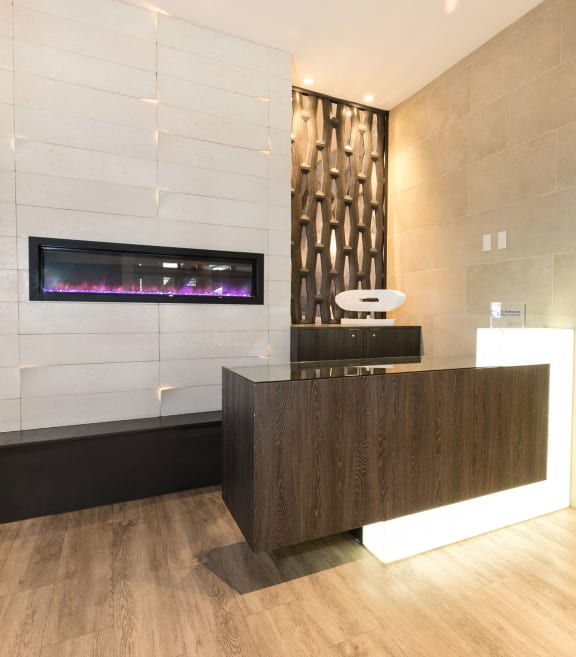 the lobby of a hotel with a reception desk and a fireplace at Apartments at Denver Place, Colorado, 80202