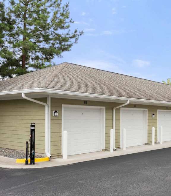 A long building with a parking lot in front.