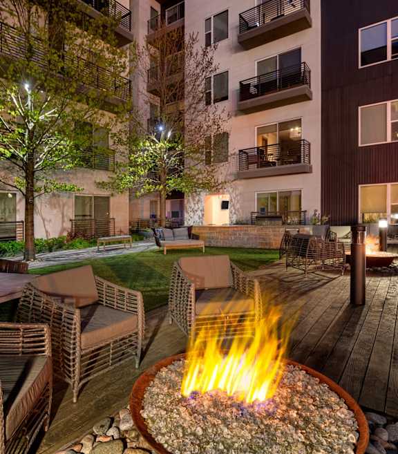 an apartment building with a large pool in front of it