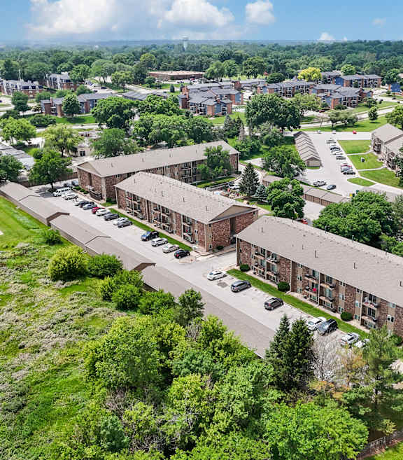 A large building complex with a parking lot in front.