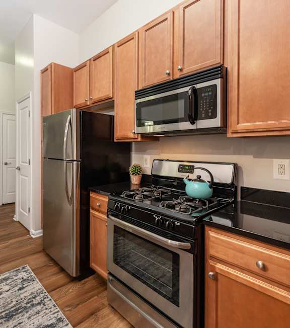 A kitchen with wooden cabinets and stainless steel appliances.