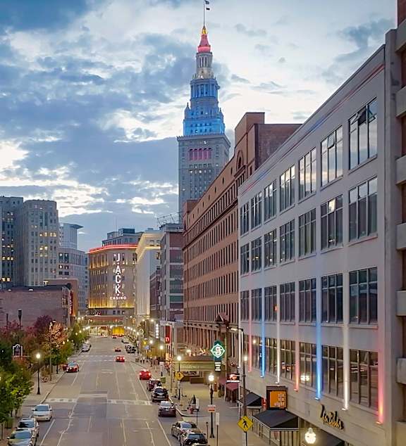 A city street with a tall building in the background.