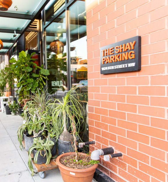a brick building with a sign on the wall that reads the shy parking