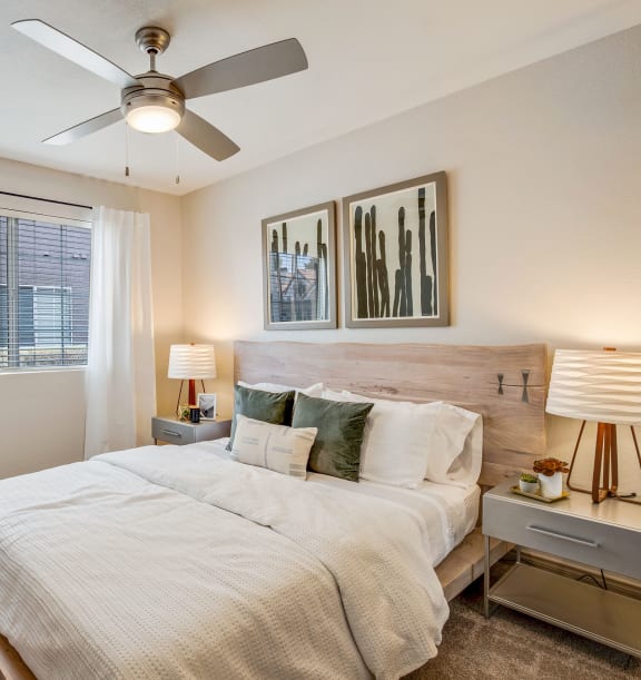 a bedroom with a large bed and a ceiling fan