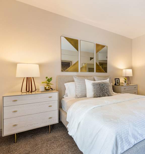 a bedroom with a white bed and a mirror at Mirasol Apartments, Las Vegas, 89119