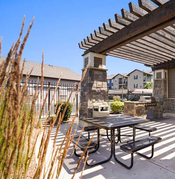 A patio with a table and chairs under a pergola.at Florentine Villas, Utah, 84047