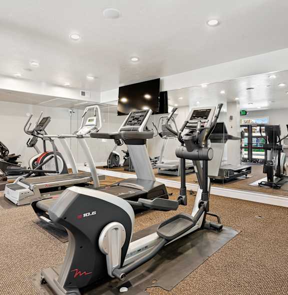 A gym with treadmills and elliptical machines.at Florentine Villas, Utah