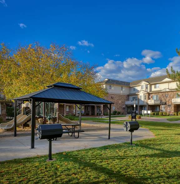 A park with a playground and a gazebo.