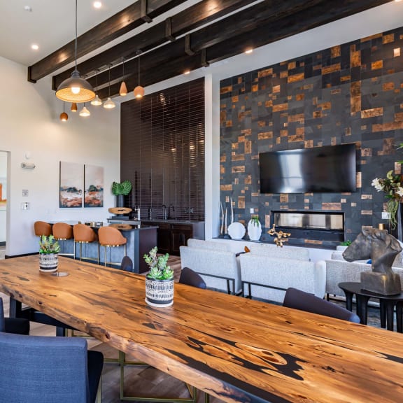 a living room with a wooden table and a fireplace