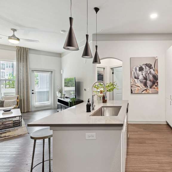 A modern kitchen with a large island and stainless steel appliances.