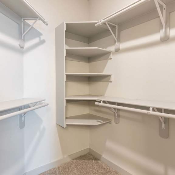 Empty white shelves in a room.