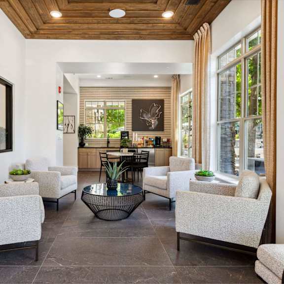 A spacious living room with a wooden ceiling and a large mirror on the wall.