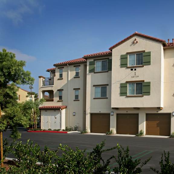 The front of the Mesa Vista Apartments building with a flag flying in the background.