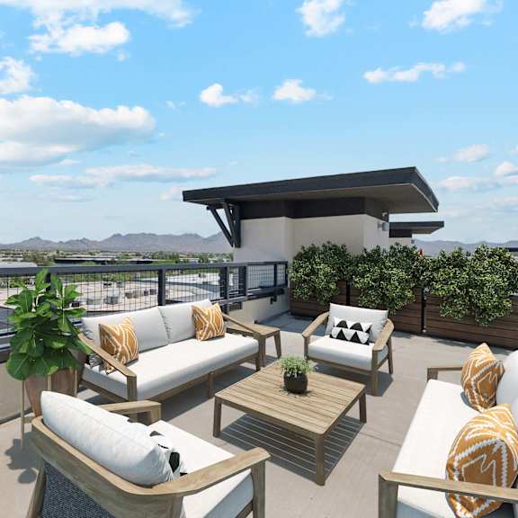 A modern outdoor living space with a fire pit and comfortable seating.
