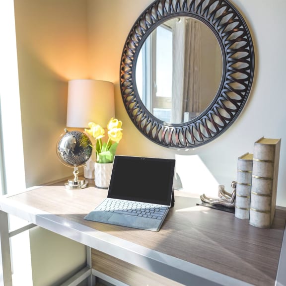 a bedroom with a bed and a desk and a window