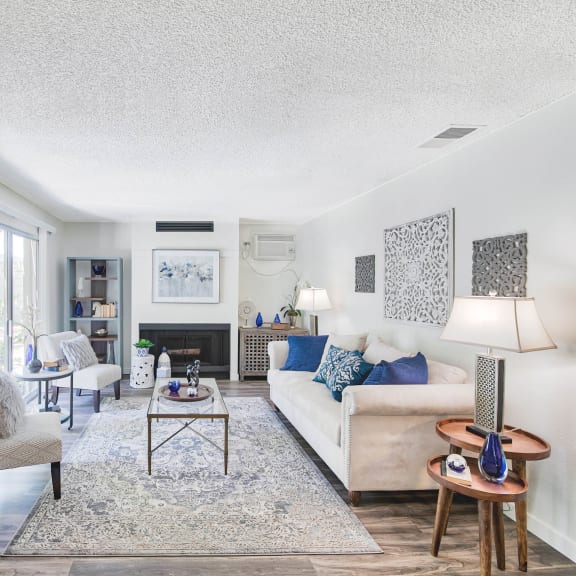 a living room with a couch and chairs and a fireplace  at Mediterranean Village Costa Mesa, Costa Mesa, California