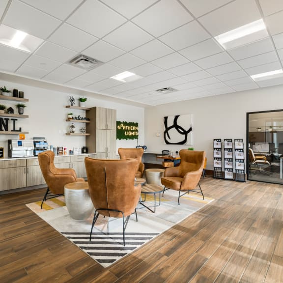 the waiting room of a salon with chairs and a table at Northern Lights a Lifestyle-Driven Community, West Fargo, North Dakota