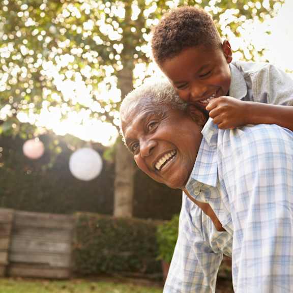 a young boy riding on the shoulders of an older man at The Carillon, Greensboro, NC, 27455