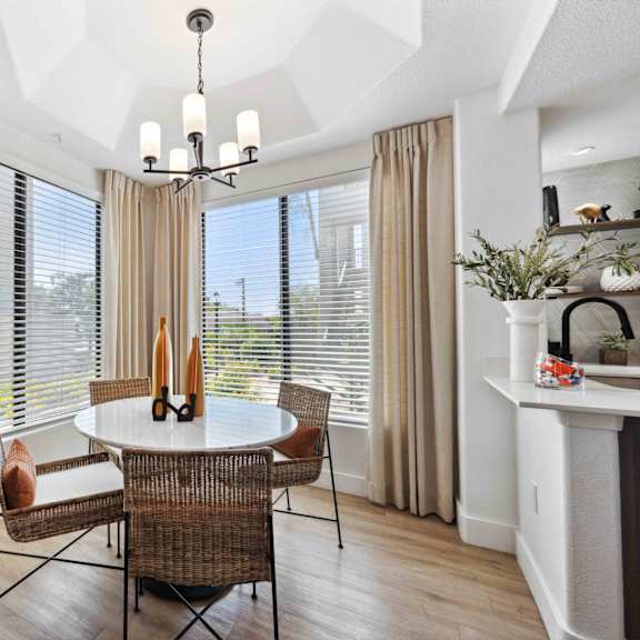 A dining room with a round table and chairs.