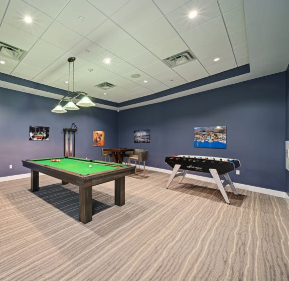 a games room with a pool table and foosball