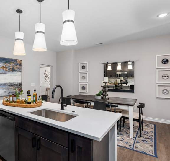 A kitchen with a large island and a painting hanging on the wall.